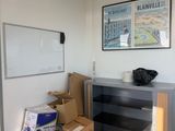 a room with a desk and a lot of boxes