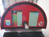 a red and black machine that has a lot of numbers on it