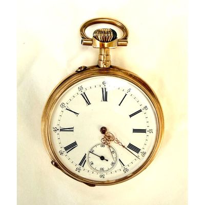 une montre de poche en or avec des chiffres romains