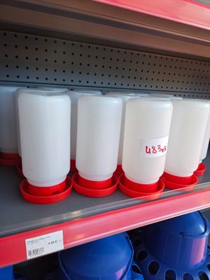 a shelf with several plastic containers on it in a store