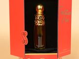 packaging of a perfume bottle in a red box with a butterfly on it