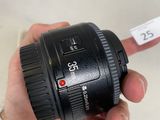 a person holding a camera lens in their hand