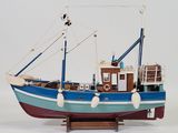a model of a boat on a stand on a white surface