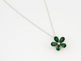 a close up of a necklace with a four leaf clover on it