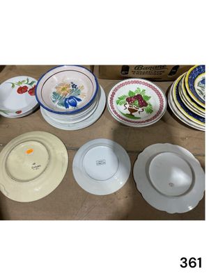 many plates and bowls sitting on a table