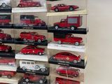 many different types of toy cars in a display case