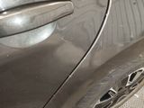 a close up of a car door handle with a hole in it