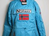 une veste bleue ornée du drapeau norvégien, accrochée au mur
