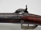 a close up of a rifle on a white background with a cat on it