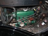a green engine in the trunk of a black car