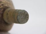 a close up of a wine bottle with a cork stopper