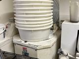 a stack of dishes sitting on top of a washing machine