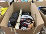 a cardboard box filled with assorted items in a pile