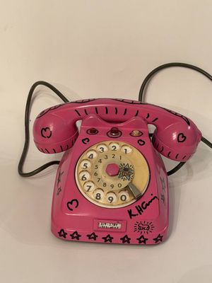 a pink telephone with a star design on it