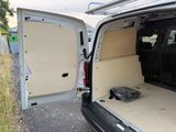 a white van with the back door open and a dog in the back