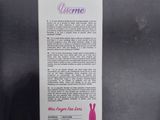 a pink box with a white label on it sitting on a black surface