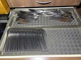 a drawer full of forks and spoons in a kitchen