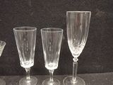 three wine glasses sitting on a table next to a bowl