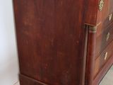 a wooden dresser with a marble top in a room