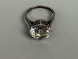 a ring that has a diamond in it on a table