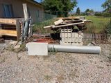 a pile of wood sitting on the ground next to a building