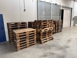 several pallets of wood are stacked up in a warehouse