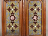 pair of antique stained glass doors with horse medallions