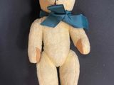 a small teddy bear with a blue bow on it ' s neck