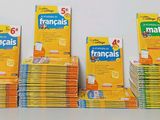several boxes of french language books stacked on top of each other