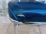 a blue chair that has a hole in the seat