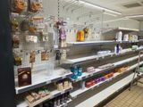 many shelves in the store that have various items on them