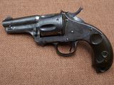a close up of a gun on a brown surface