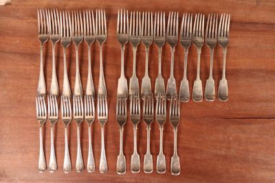 a set of six forks and a knife on a wooden table