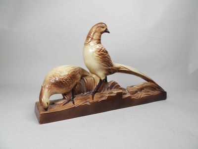 two birds are sitting on a wooden block with a white background