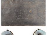 a close up of a metal object on a white surface