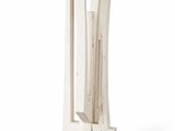 a white sculpture on a wooden base on a white background