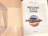 someone is holding a book with a picture of a plane in it