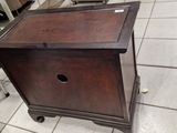 a small wooden cabinet on wheels in a store