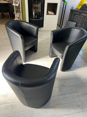 two black chairs that are sitting in a living room