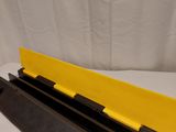 a close up of a black and yellow rail on a white background