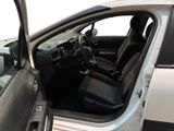 the interior of a car with the door open and the driver ' s seat down