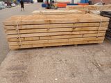 several pieces of wood are stacked on top of each other in a parking lot