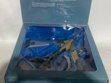 toy gun in a box on a white surface with a blue background