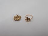 a pair of gold rings on a white surface