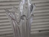 a clear glass vase with a bird on it