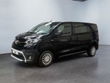 the black van is parked in a large room with white walls