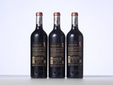 three bottles of wine sitting on top of a table next to each other