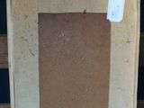 an old picture frame sitting on top of a wooden bench
