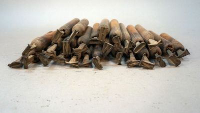 a pile of wood sticks on a white surface