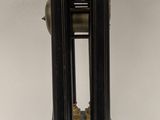 a black and gold clock sitting on a white table